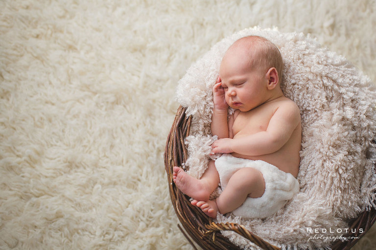 Simple newborn photography - baby in a basket with soft neutral tones