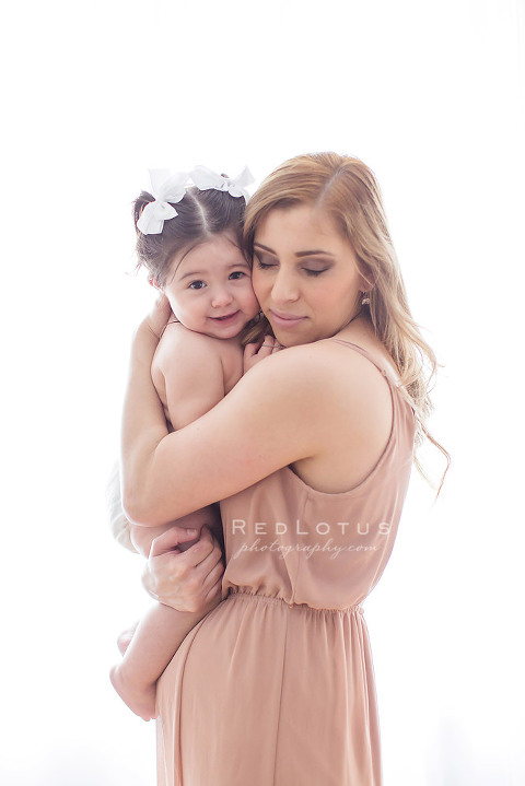 mommy and me portraits natural pose with neutral colors in the studio