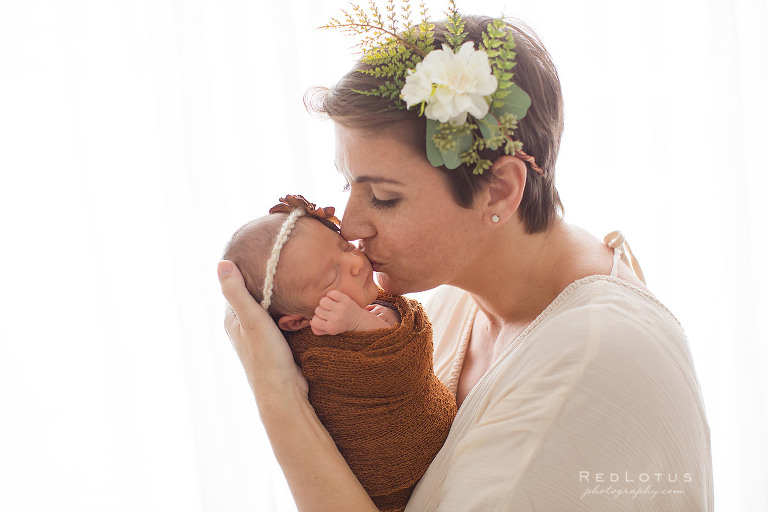 newborn photography mother and baby kiss