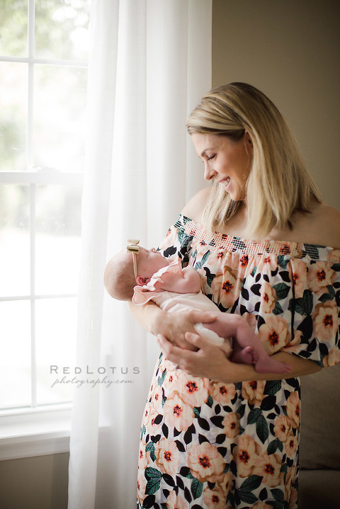 newborn photography at home mom and baby by a window