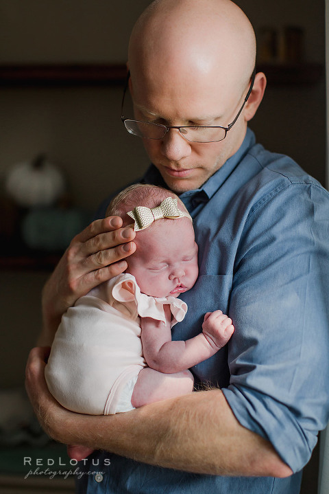 newborn photography dad holding baby