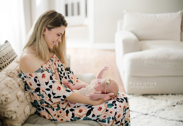 lifestyle newborn photography mom holding baby in lap