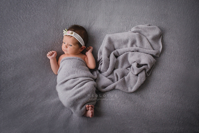 newborn photography baby girl on grey blanket and grey wrap