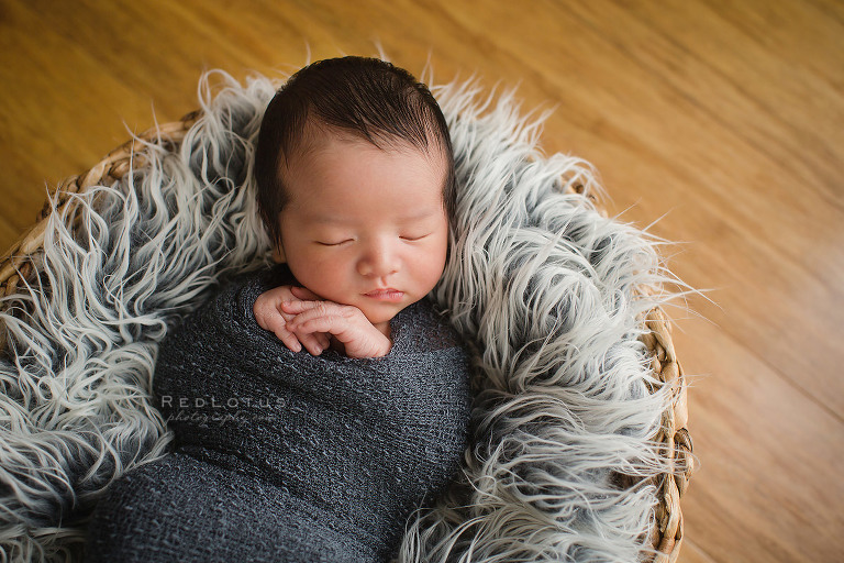 newborn photography Chinese baby sleeping in basket