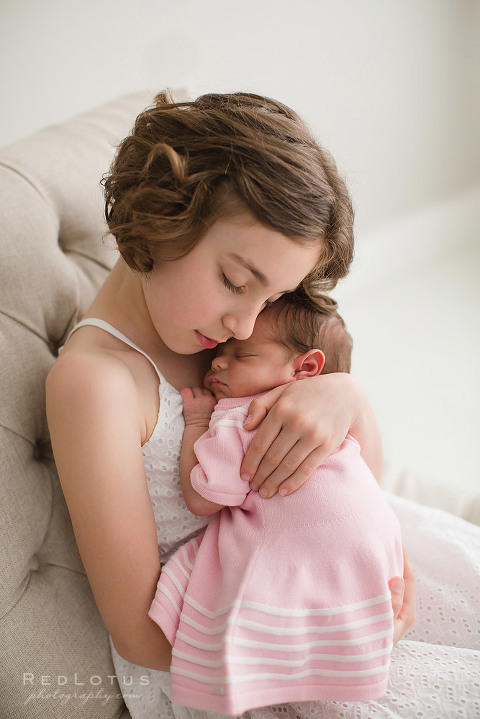 newborn and sibling pose