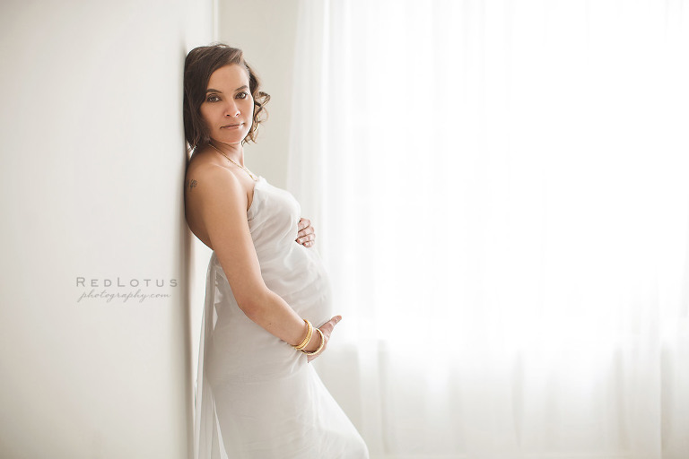 beautiful pregnancy photos woman in white fabric holiding baby bump