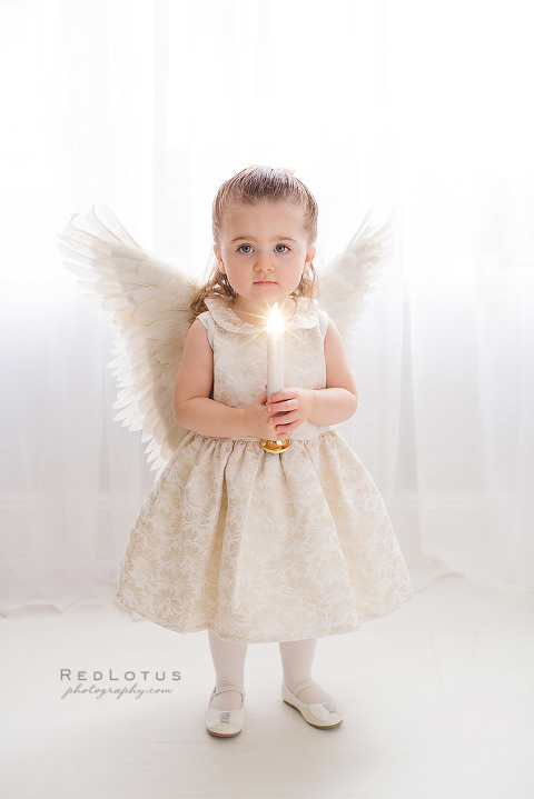 Christmas holiday photos child with angel wings holding candle holiday photo ideas
