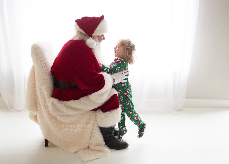 child runnign to Santa to be picked up