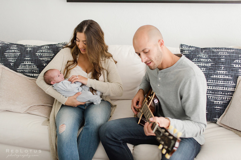 newborn session dad plays guitar for baby