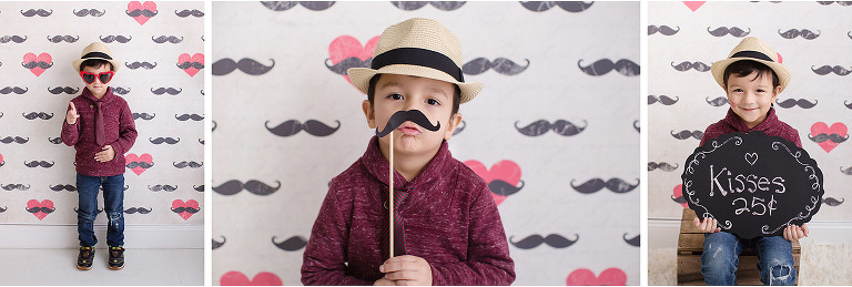 Valentine mini photo session mustache backdrop boy wearing hat kisses sign