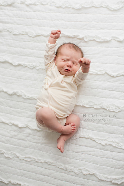 newborn photography baby stretching unposed