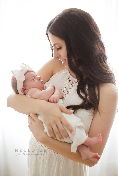 newborn photography mother and baby pose light and airy backlit window