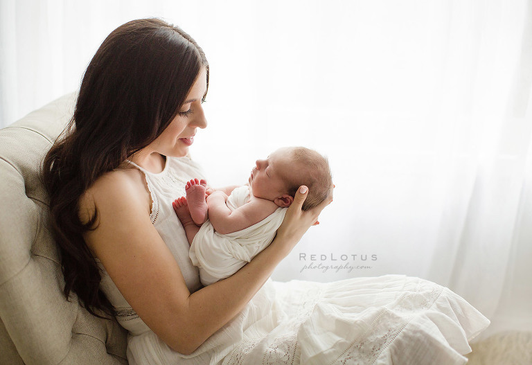 newborn photography mother and baby light airy backlit window neutral colors natural light studio