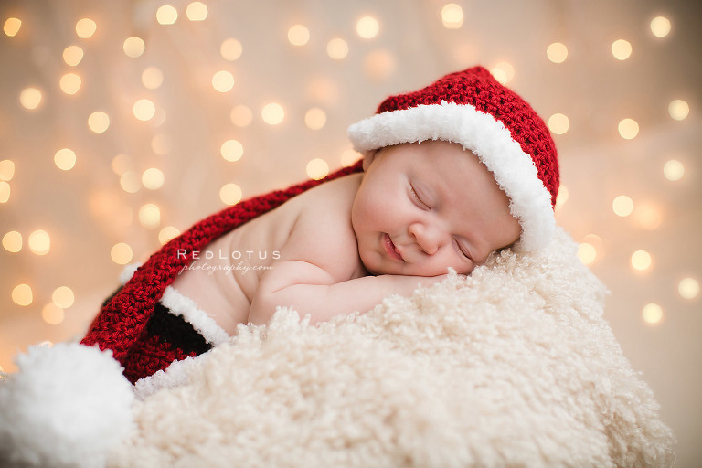 newborn photography twinkle lights Christmas photo baby in basket with Santa hat