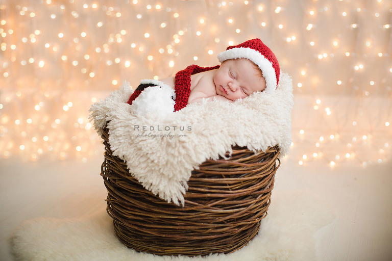 newborn photography twinkle lights Christmas photo baby in basket with Santa hat
