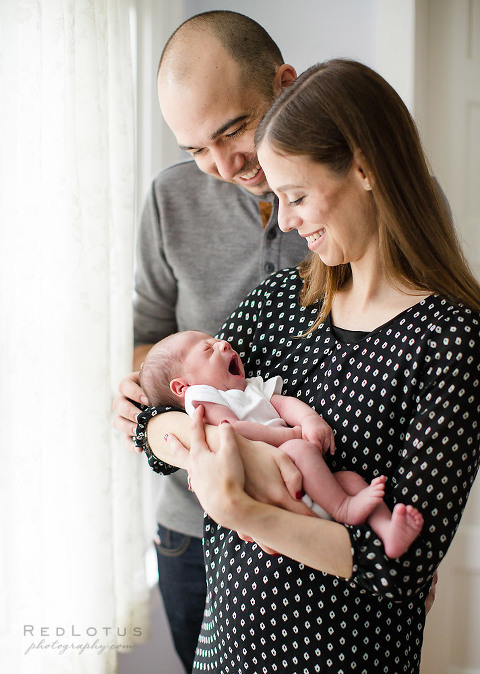 newborn photography baby yawning parents smiling