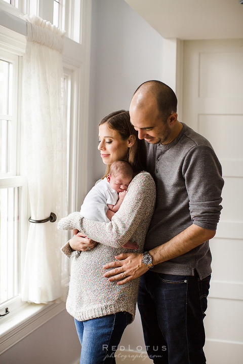 home newborn photography session natural light lifestyle newborn photography photographer pittsburgh parents holding baby