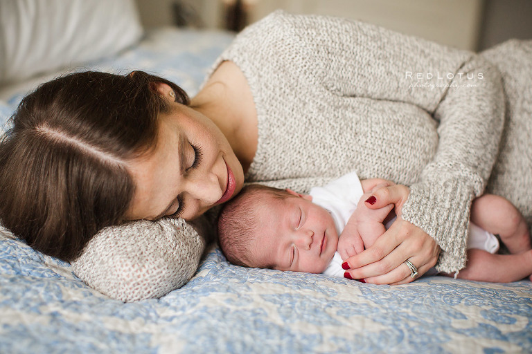 newborn photography mother laying on bed with baby natural pose
