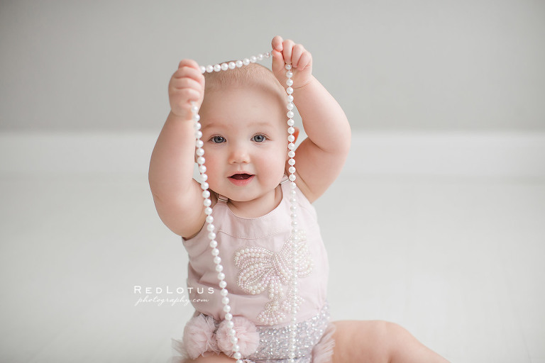 toddler baby girl peekaboo with string of pearls