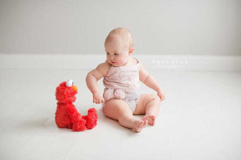 toddler girl with Elmo plush