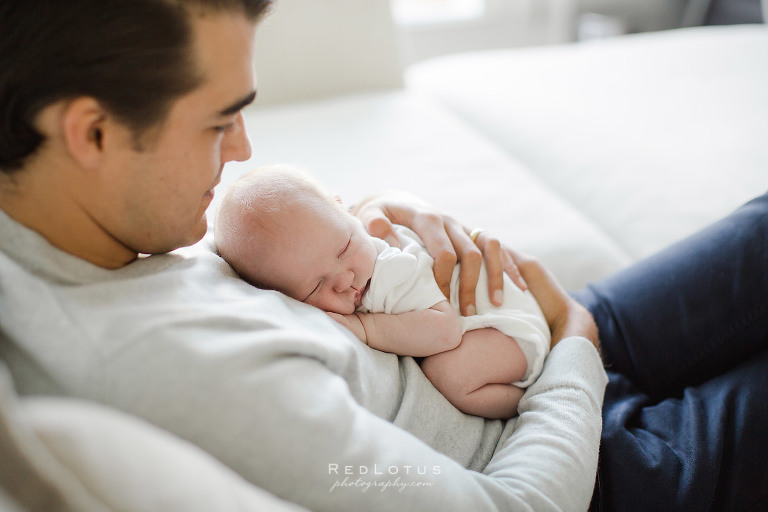 dad holding baby on his chest
