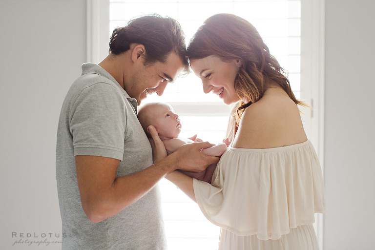lifestyle newborn photography parents and baby pose