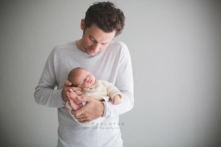 newborn photography pose dad holding baby