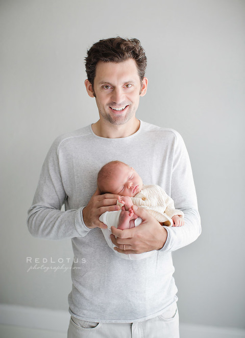newborn photography pose dad holding baby