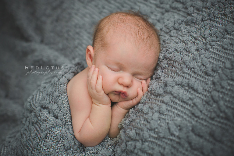 newborn baby photography baby on grey blanket
