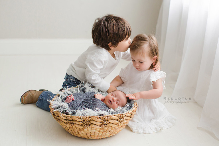 newborn and siblings photography safe pose baby in basket young children toddlers