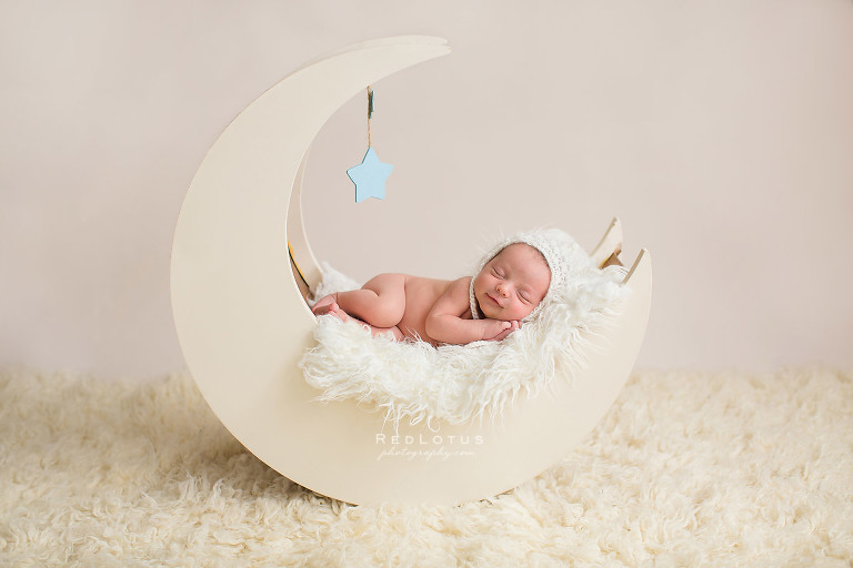 newborn photographer moon prop cute baby smiling neutral colors