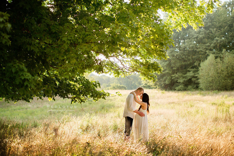 beautiful maternity photos nature outdoors couple under tree