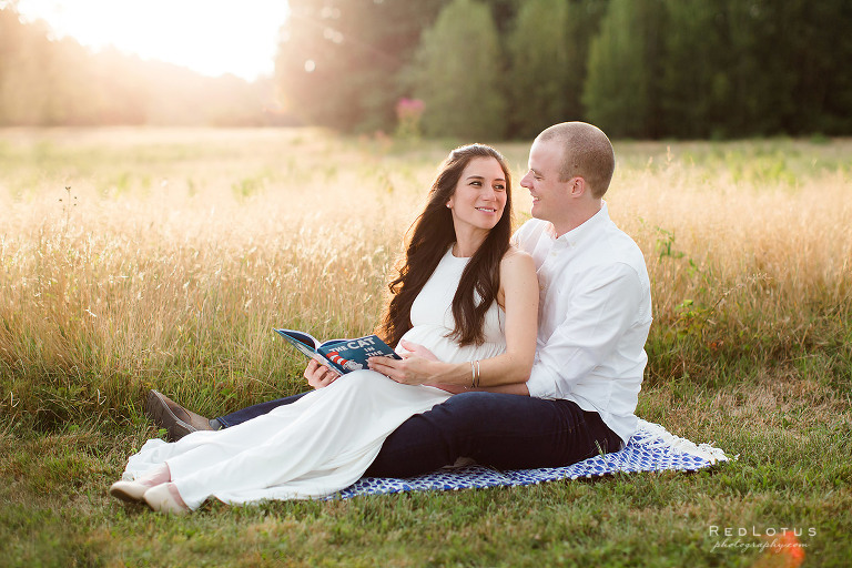 maternity photo ideas reading baby book together beautiful outdoors field nature