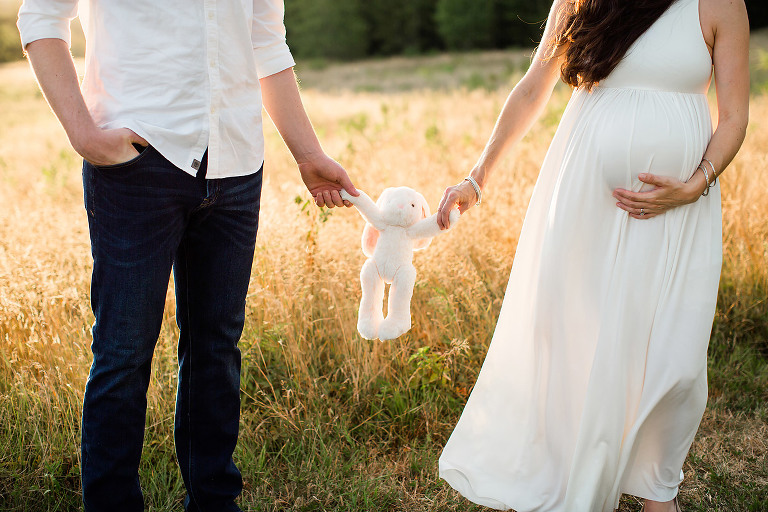 maternity photo ideas couple holding baby toy