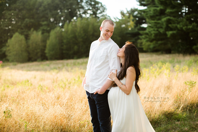 maternity photo ideas poses couple standing smiling