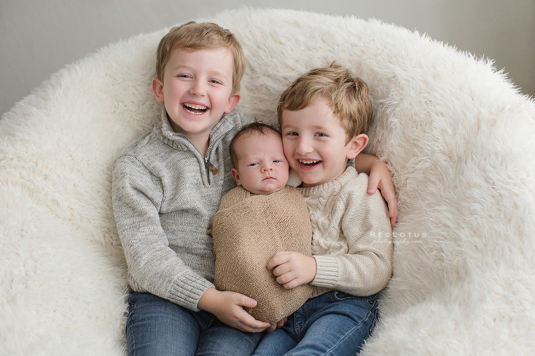 newborn photography sibling pose safe
