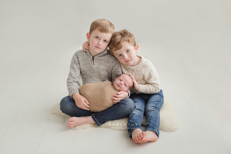 newborn photography siblings pose older