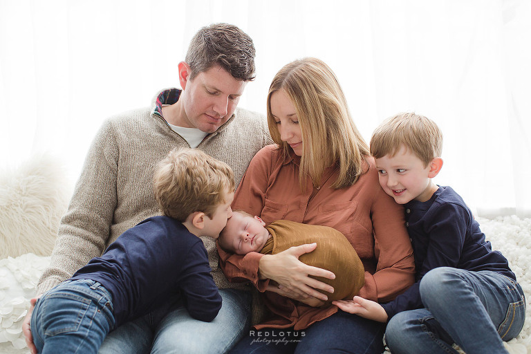 newborn photographer Pittsburgh family candid pose on bed