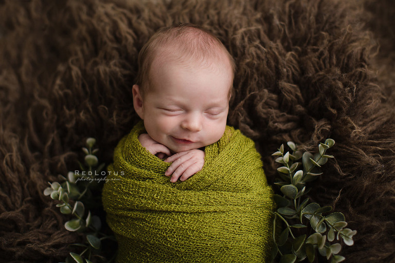 baby smiling newborn photography nature greenery foliage rustic woodsy brown and green