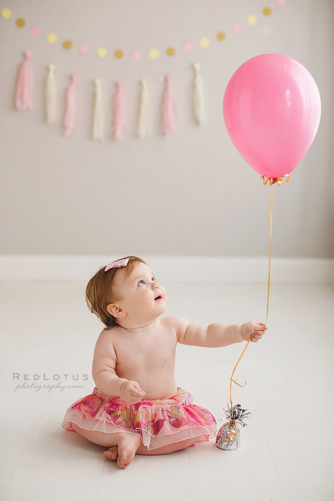 one year old birthday photos baby girl with pink balloon