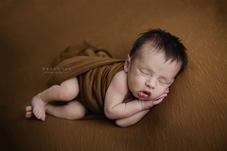 newborn baby sleeping peacefully on side