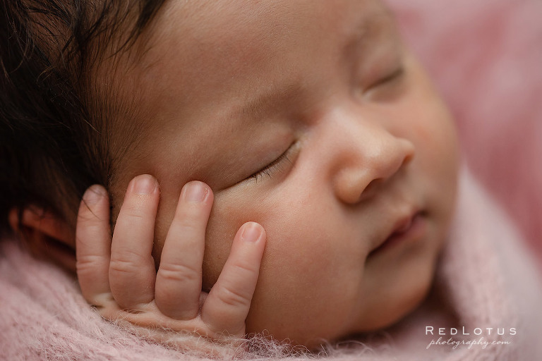 newborn baby close up of face and hand detail photo