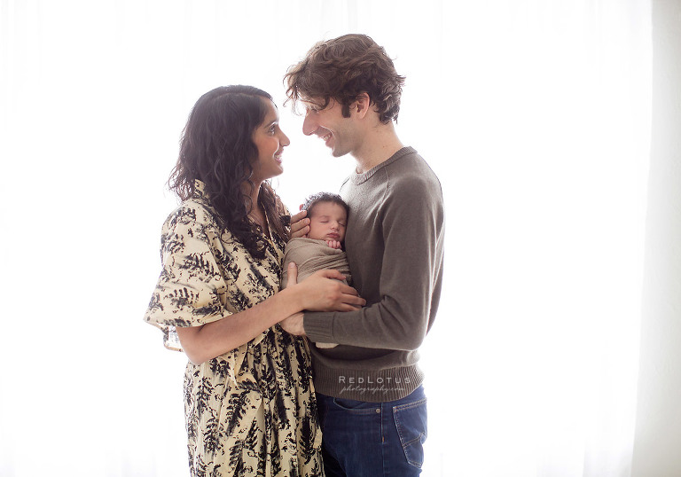 newborn photography parents and baby light airy natural pose loving