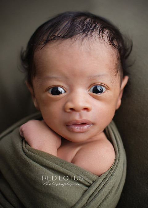 newborn photo awake baby eyes open with olive green blanket and wrap