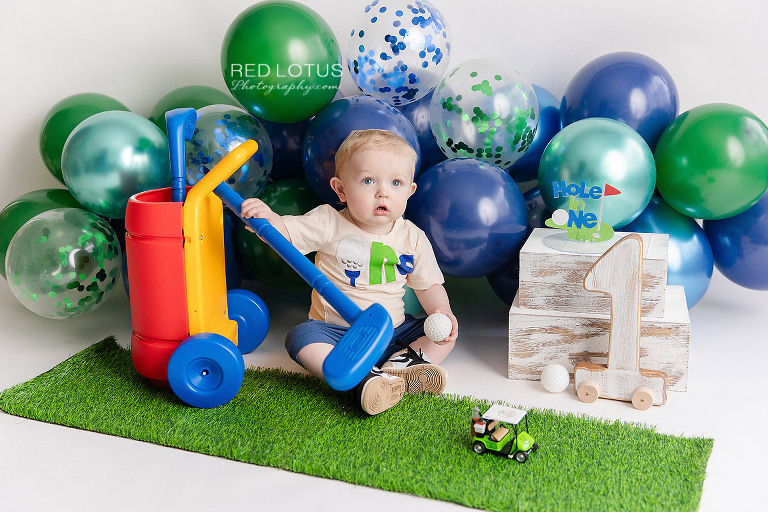 golf themed cake smash photo session for one year old boy