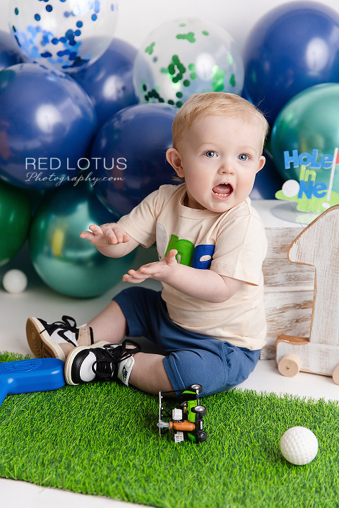 golf themed cake smash photo session for one year old boy