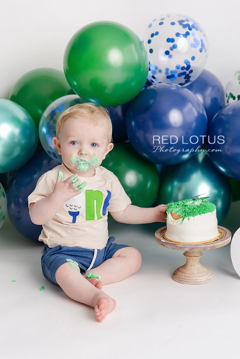 golf themed cake smash photo session for one year old boy