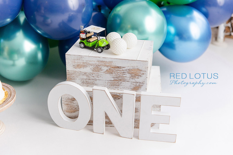 golf themed cake smash photo session for one year old boy