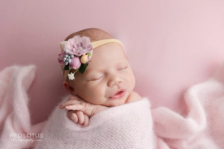 newborn photography baby girl in pink wrap and floral headband