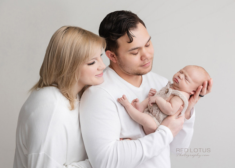 newborn photography mother and father looking at baby